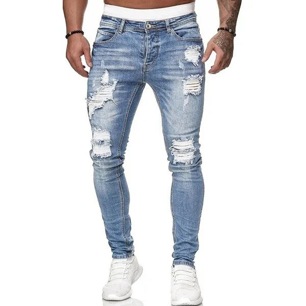 Men's slim-fit jeans with a ripped, vintage denim look. These stylish, ankle-length pants have distressed holes and a punk-inspired design.