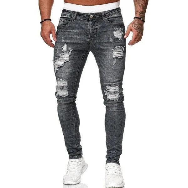 Men's slim-fit jeans with a ripped, vintage denim look. These stylish, ankle-length pants have distressed holes and a punk-inspired design.