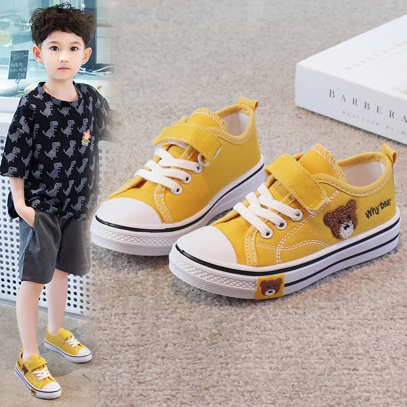 set of children's canvas shoes, specifically designed for girls and boys, featuring a cartoon bear design for a soft-bottomed casual sneaker.