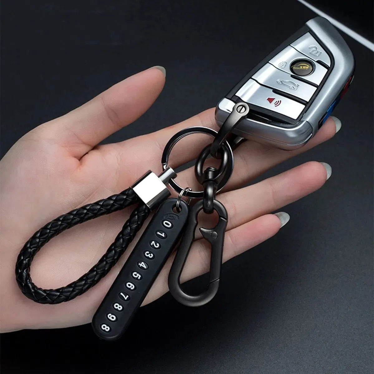 Trendy DIY mobile phone number plate keychain for men in punk style with woven leather rope. Perfect anti-lost accessory.