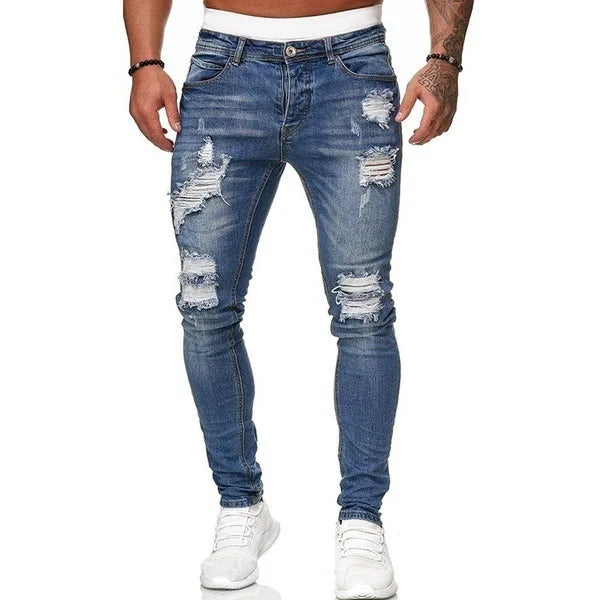 Men's slim-fit jeans with a ripped, vintage denim look. These stylish, ankle-length pants have distressed holes and a punk-inspired design.